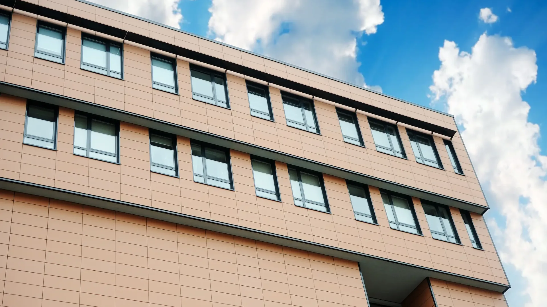 Exterior of a modern office building against a blue sky